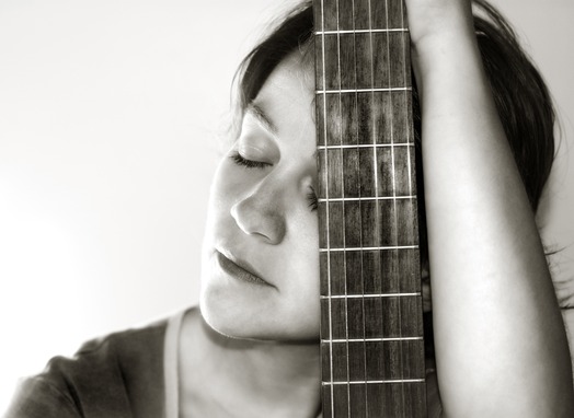 Sad Female Guitarist At Rocking Gods House